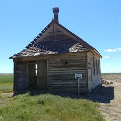 Picture of decrepit old wooden church in a field